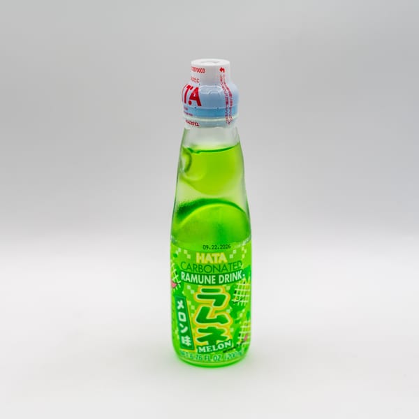 A bottle of green Hata Carbonated Ramune Drink in Melon flavor on a white background.