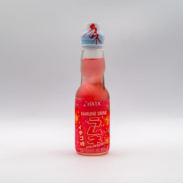 A bottle of Hata strawberry-flavored carbonated Ramune drink with a red and blue cap.