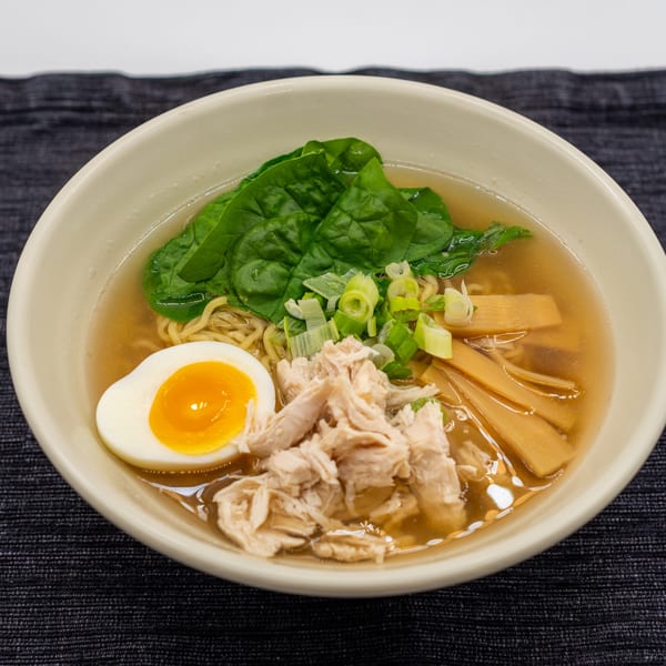 Tanpopo Ramen with chicken, spinach, bamboo shoots, green onions, and a soft-boiled egg.